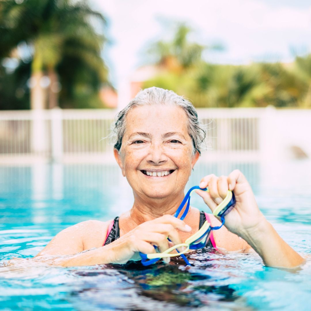 Senior woman smiling in pool