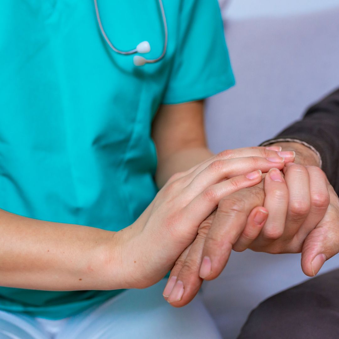 Holding hand of senior person