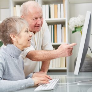 seniors learning together on a computer