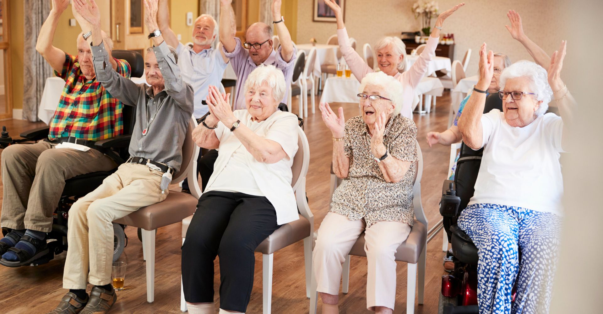 seniors in a senior center doing chair aerobics