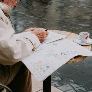 Senior Man Solving a Newspaper Crossword