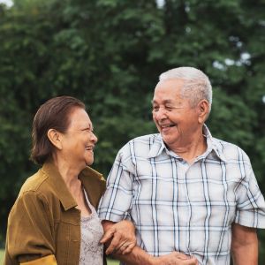 Elderly Couple Linking Arms at the Park