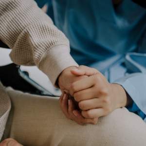Holding the hand of an elderly individual