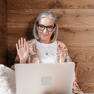 Woman waving on a video call
