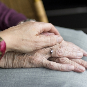 Woman's hand on an elderly hand