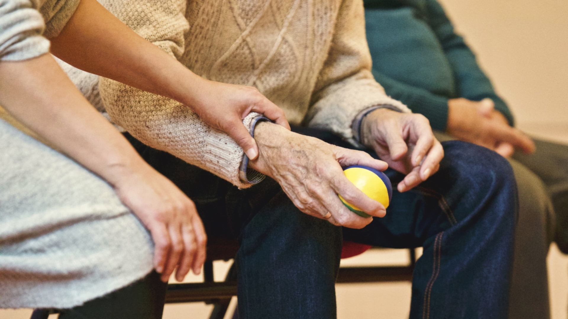 Elderly hand holding a ball