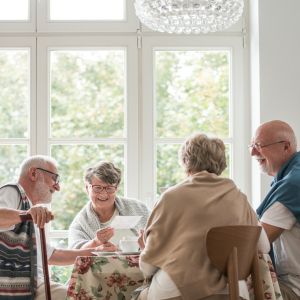 Seniors socializing in a brightly lit room.