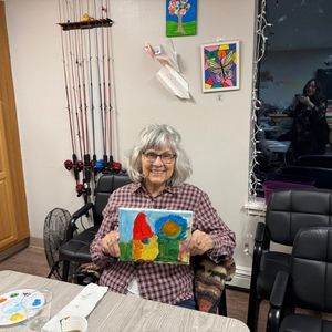 senior resident with painting